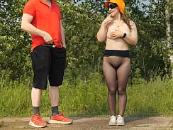 The girl, in sheer pantyhose, bends over, her ass up, her head down, as she masturbates the passerby, his moans filling the outdoor air